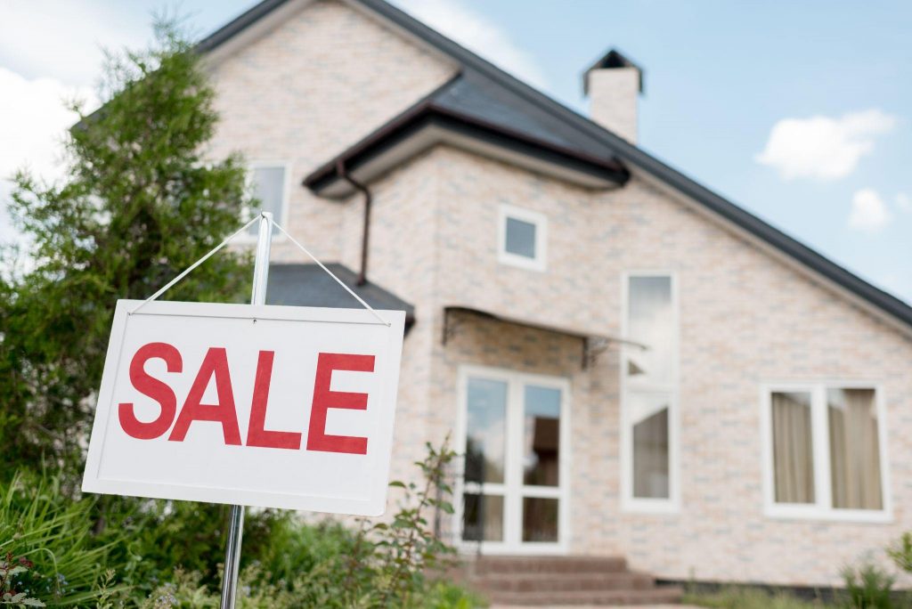 Home with for sale sign in front