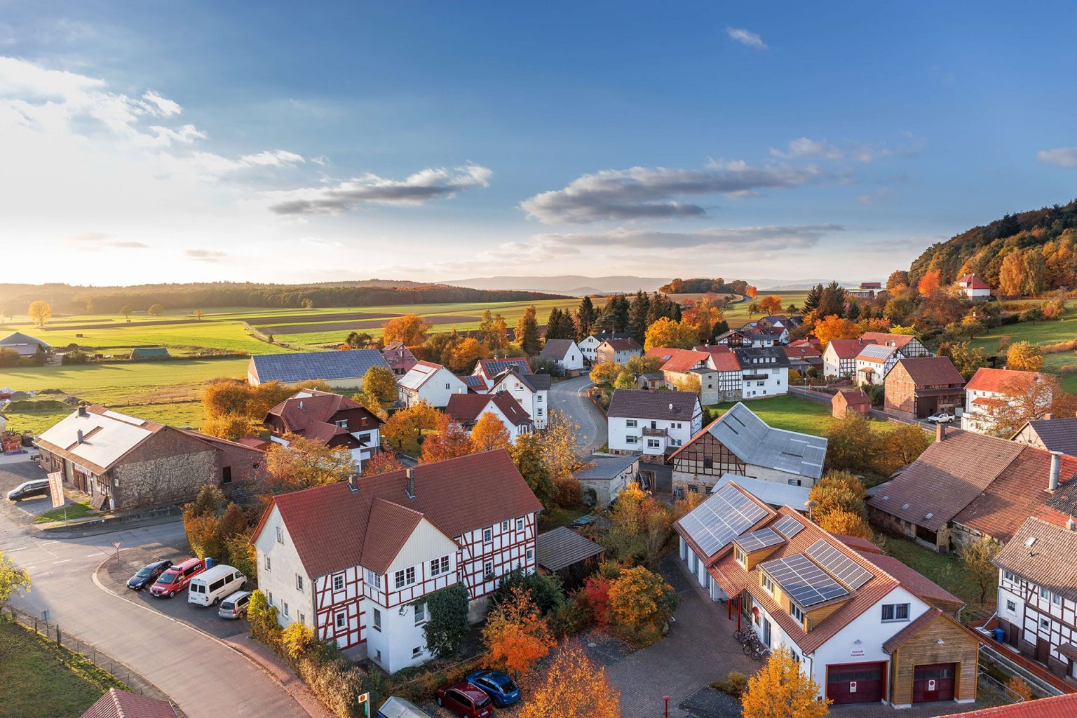 Arial view of Kleinburg with multiple houses in view and autmn forests visible in the distance