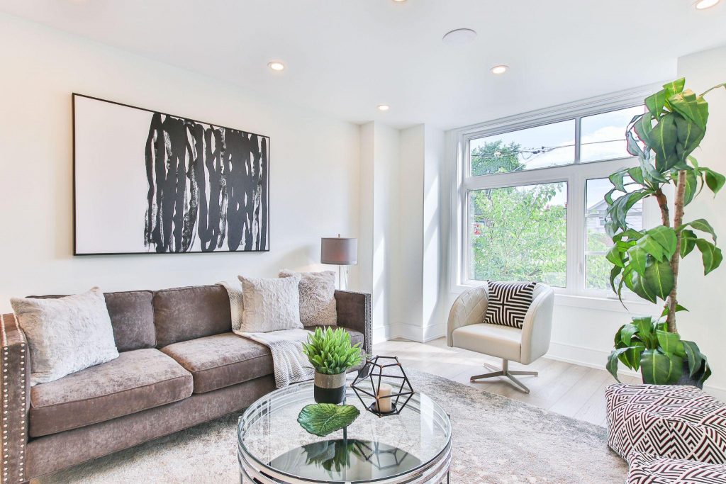 Renovated living room with matching furniture wall decorations and plants